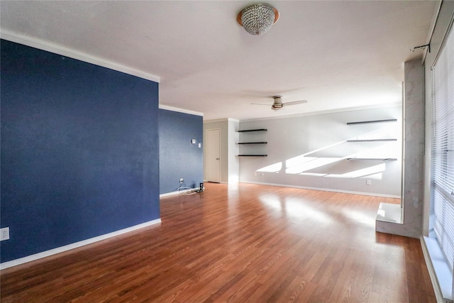 unfurnished living room featuring hardwood / wood-style flooring, ceiling fan, and ornamental molding