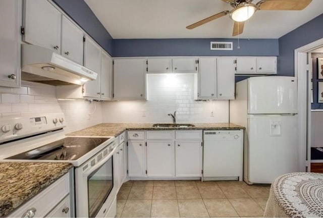 kitchen with light tile patterned flooring, white cabinetry, sink, light stone counters, and white appliances