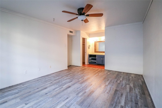 interior space featuring wood-type flooring, ceiling fan, and crown molding