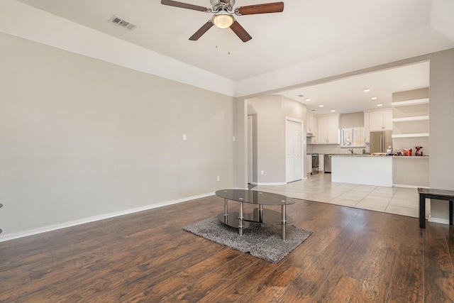 unfurnished living room with light hardwood / wood-style flooring and ceiling fan