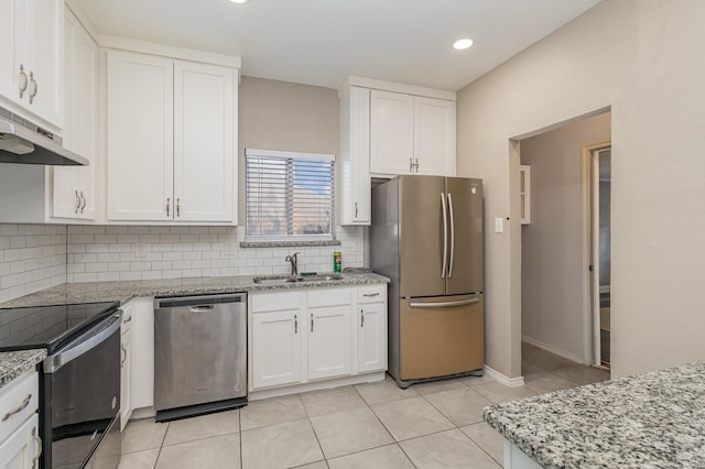 kitchen with white cabinetry, sink, light stone counters, and stainless steel appliances