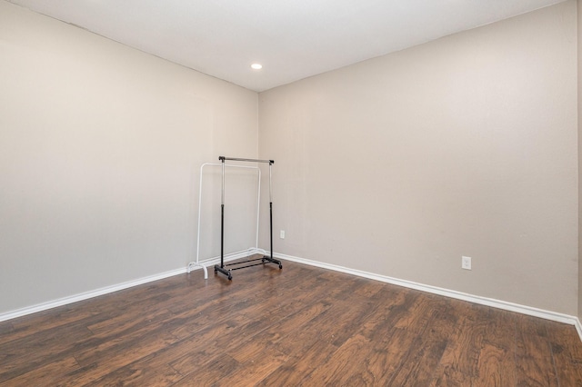 spare room featuring dark wood-type flooring