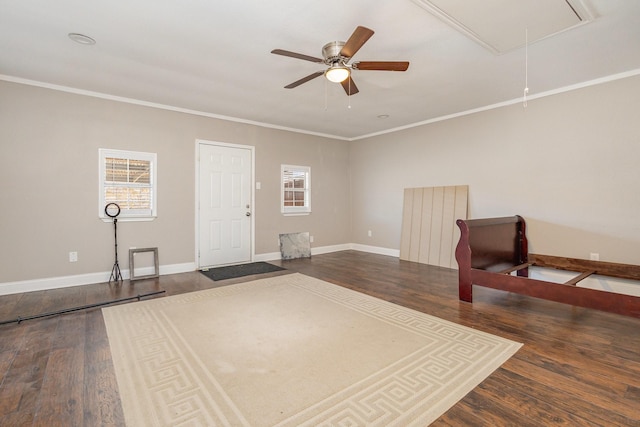 interior space with ornamental molding, dark wood-type flooring, and ceiling fan