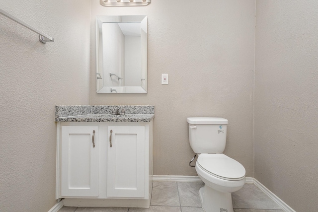 bathroom featuring vanity, toilet, and tile patterned flooring