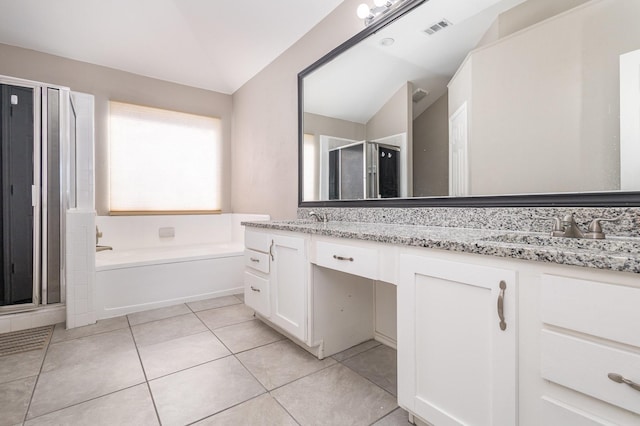 bathroom with tile patterned flooring, vanity, lofted ceiling, and plus walk in shower