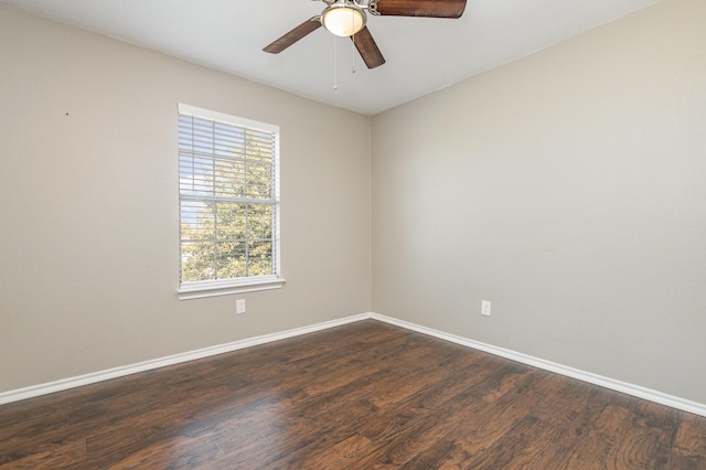 spare room with dark wood-type flooring and ceiling fan