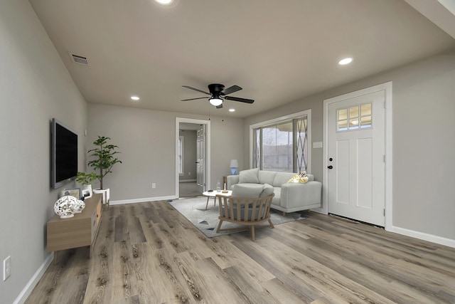 living room featuring hardwood / wood-style flooring and ceiling fan