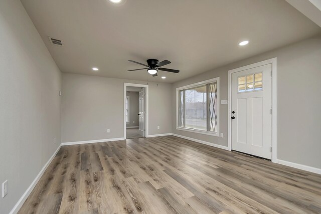 living room featuring hardwood / wood-style floors and ceiling fan