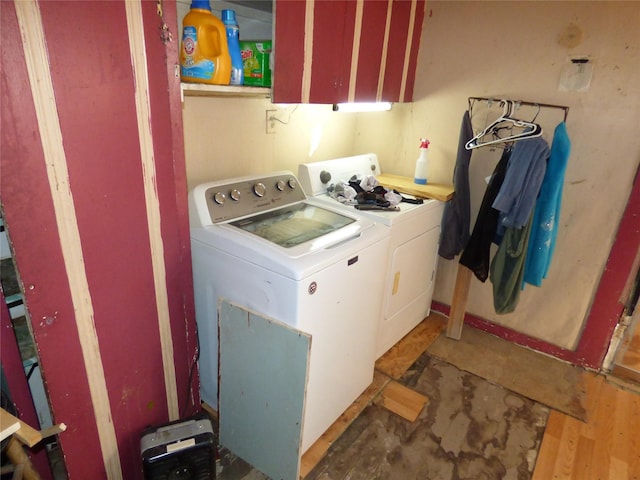 clothes washing area with washing machine and dryer