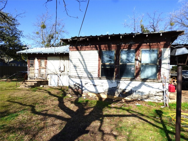 view of side of home featuring a lawn