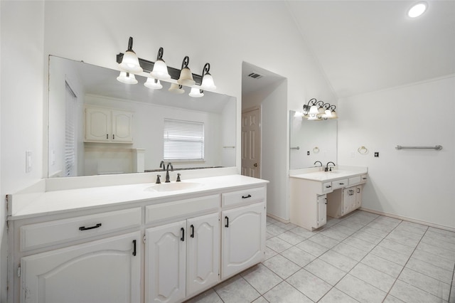 bathroom with tile patterned flooring, vanity, and lofted ceiling