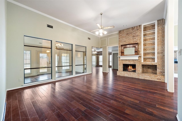 unfurnished living room with hardwood / wood-style floors, crown molding, a fireplace, and ceiling fan