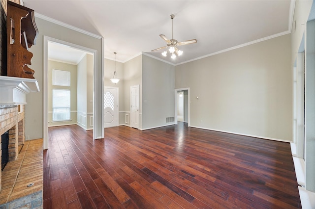 unfurnished living room featuring dark hardwood / wood-style floors, ceiling fan, ornamental molding, and a fireplace