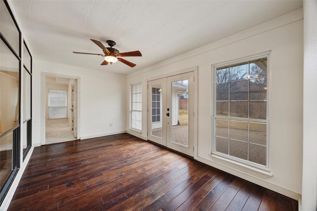 spare room featuring dark hardwood / wood-style floors, ceiling fan, and french doors