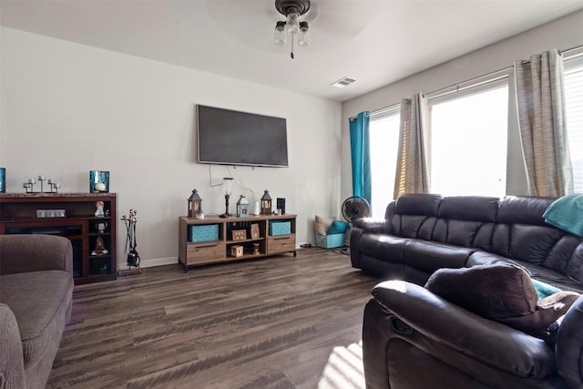 living room featuring ceiling fan and dark hardwood / wood-style flooring