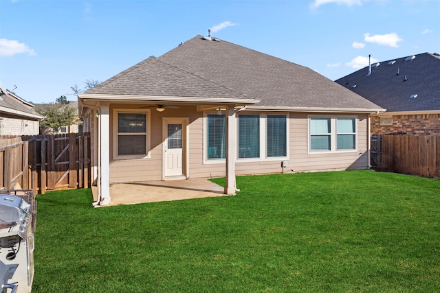 back of house featuring a yard, a patio area, and ceiling fan