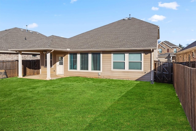 back of property featuring a patio area and a lawn