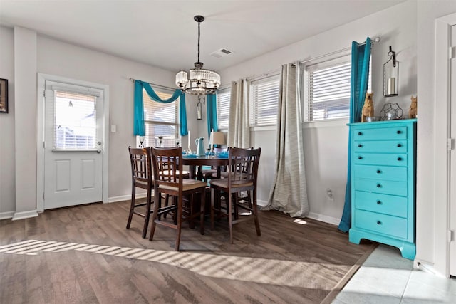 dining space with a chandelier and hardwood / wood-style floors