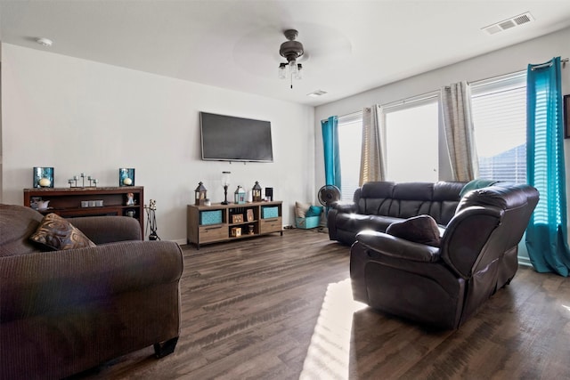 living room with ceiling fan and dark hardwood / wood-style flooring