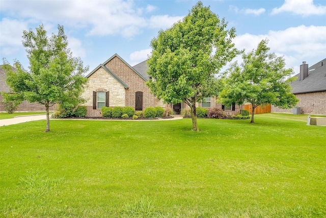 957 Prairie Timber Rd, Burleson, TX 76028 - view of front of home featuring stone siding and a front yard