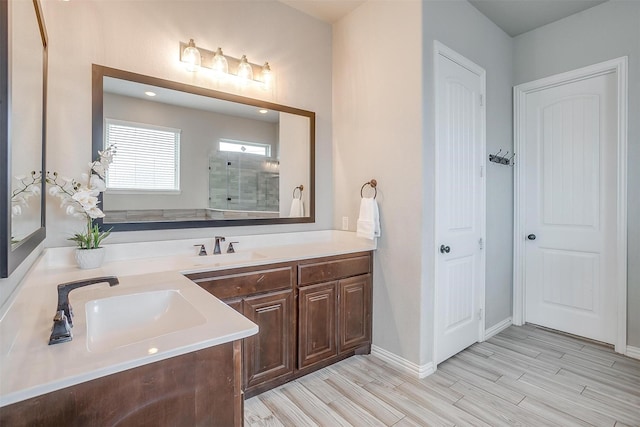 bathroom with walk in shower and vanity