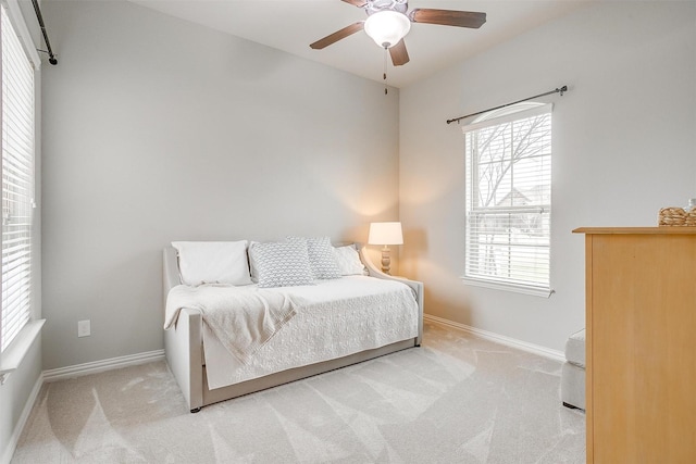 bedroom featuring ceiling fan and light colored carpet