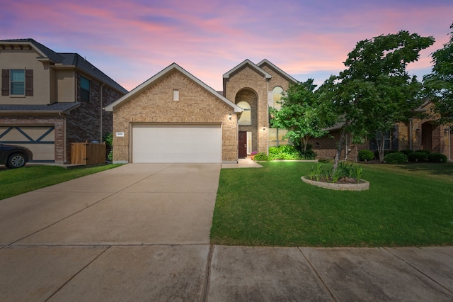 view of front of home featuring a garage and a yard