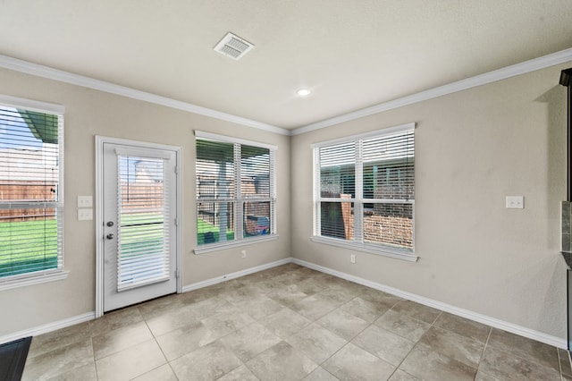 tiled empty room featuring ornamental molding