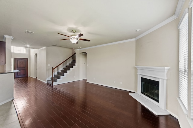 unfurnished living room with dark hardwood / wood-style flooring, crown molding, and ceiling fan