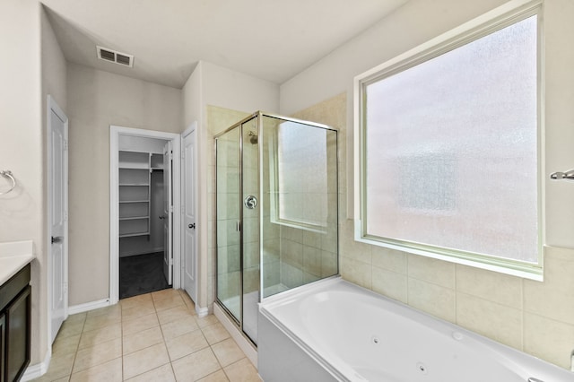 bathroom with independent shower and bath, vanity, and tile patterned floors