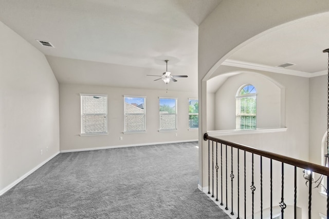 hall featuring dark colored carpet, vaulted ceiling, and ornamental molding