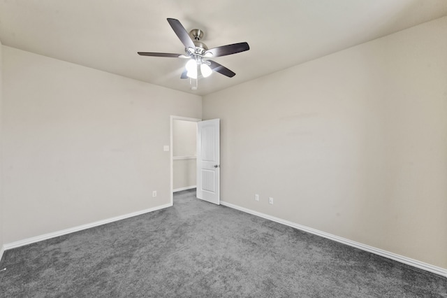 empty room with dark carpet and ceiling fan