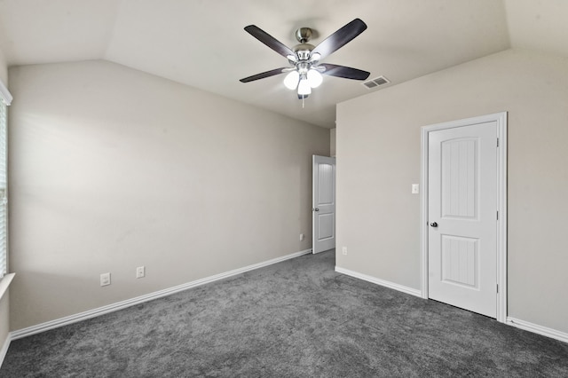 unfurnished bedroom with ceiling fan, lofted ceiling, and dark colored carpet