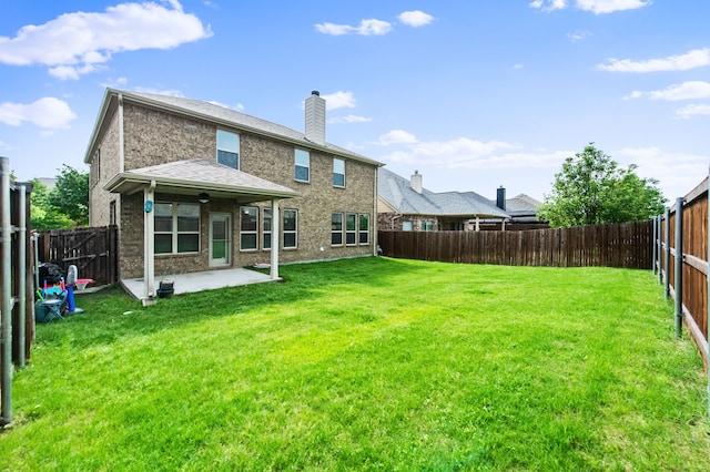 rear view of property with a patio area and a lawn