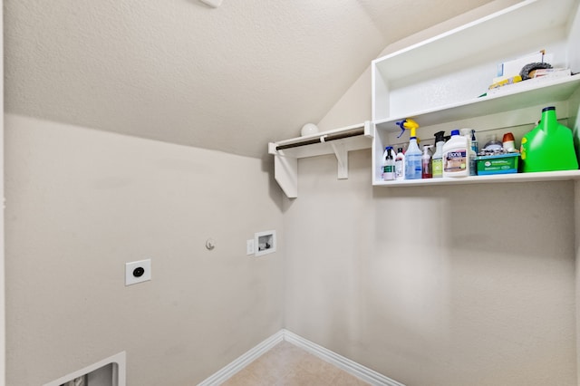 laundry area with gas dryer hookup, electric dryer hookup, washer hookup, and a textured ceiling