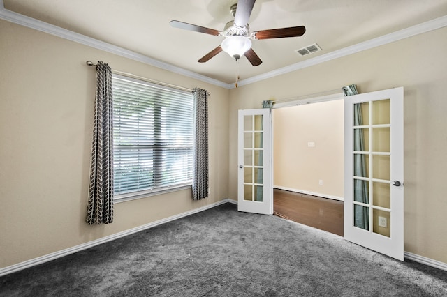 spare room with french doors, ceiling fan, ornamental molding, and dark carpet