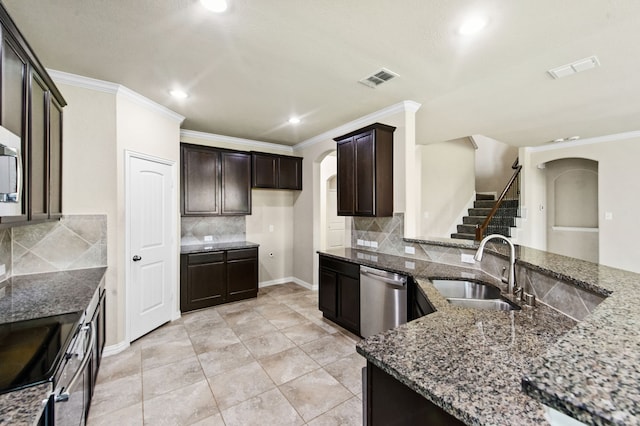 kitchen with sink, crown molding, dark brown cabinets, dark stone countertops, and stainless steel appliances