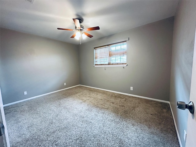 unfurnished room featuring baseboards, ceiling fan, and carpet flooring