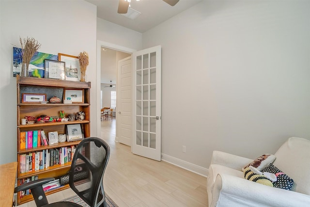 office space with ceiling fan and light wood-type flooring