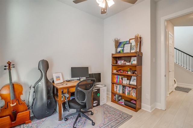 office with ceiling fan and light hardwood / wood-style floors