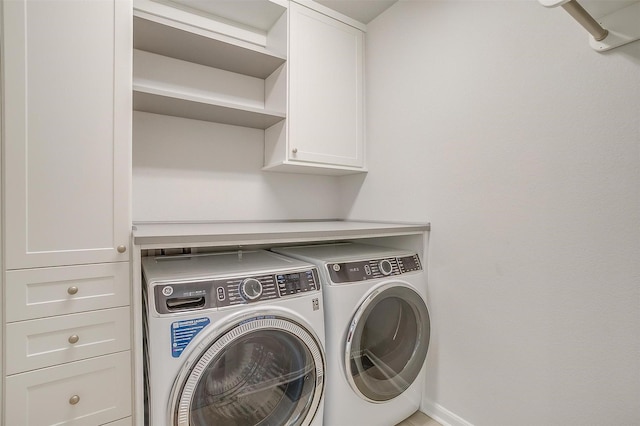 laundry area featuring cabinets and washer and dryer