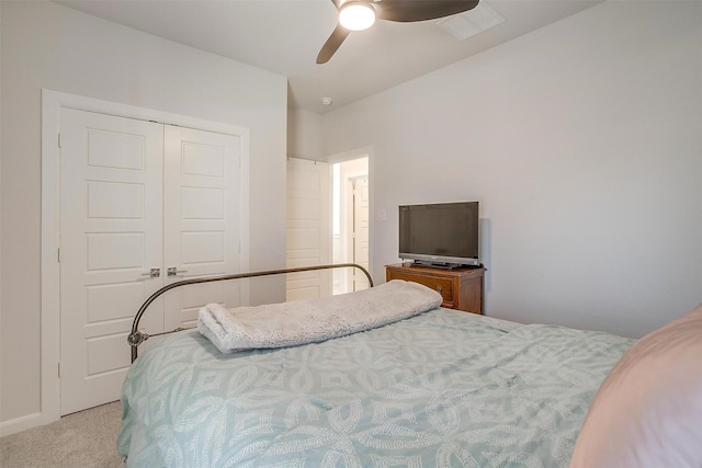 bedroom with ceiling fan, a closet, and light carpet