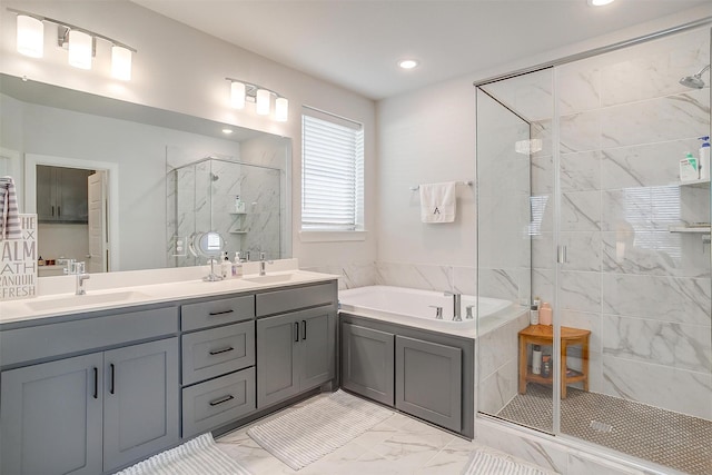 bathroom with vanity and shower with separate bathtub