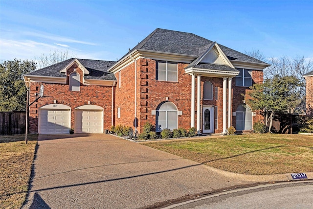 view of front of home featuring a garage and a front lawn