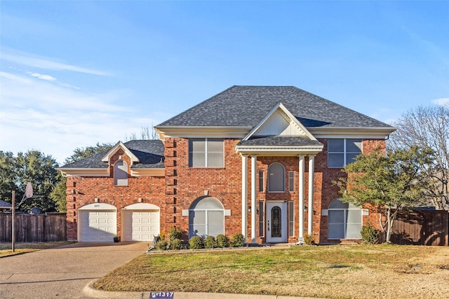 view of front of home featuring a garage and a front lawn