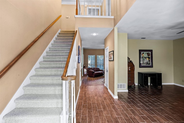 stairway with hardwood / wood-style flooring