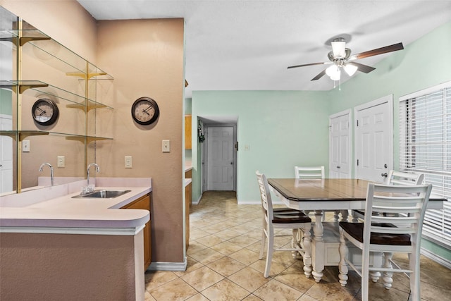 dining room featuring sink, ceiling fan, and light tile patterned flooring