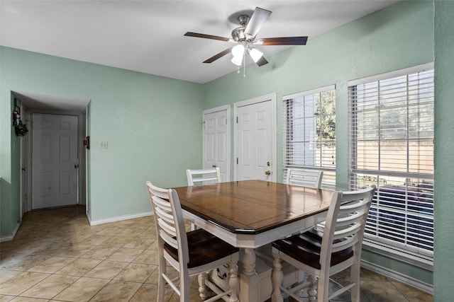 tiled dining area with ceiling fan