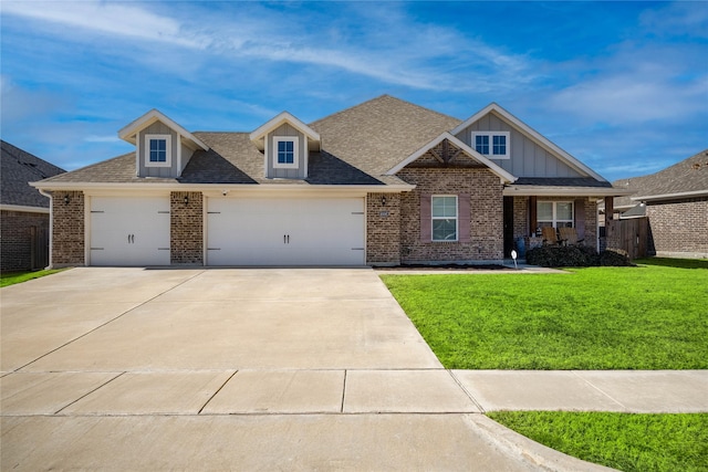 view of front of property featuring a garage and a front lawn