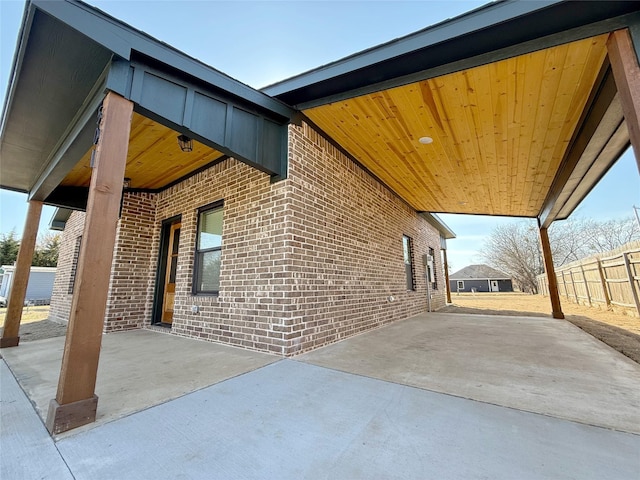 view of patio / terrace featuring a carport and fence